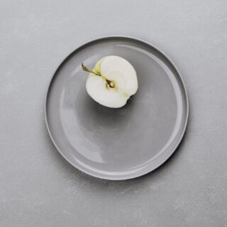 an apple on a gray plate