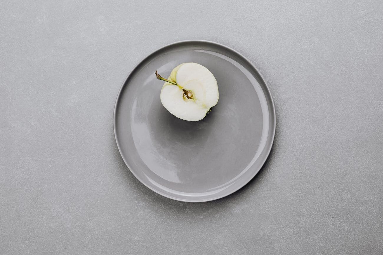 an apple on a gray plate