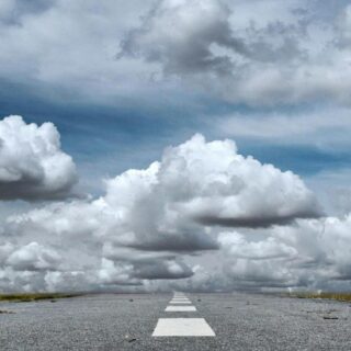 gray rolled asphalt road under cloudy sky